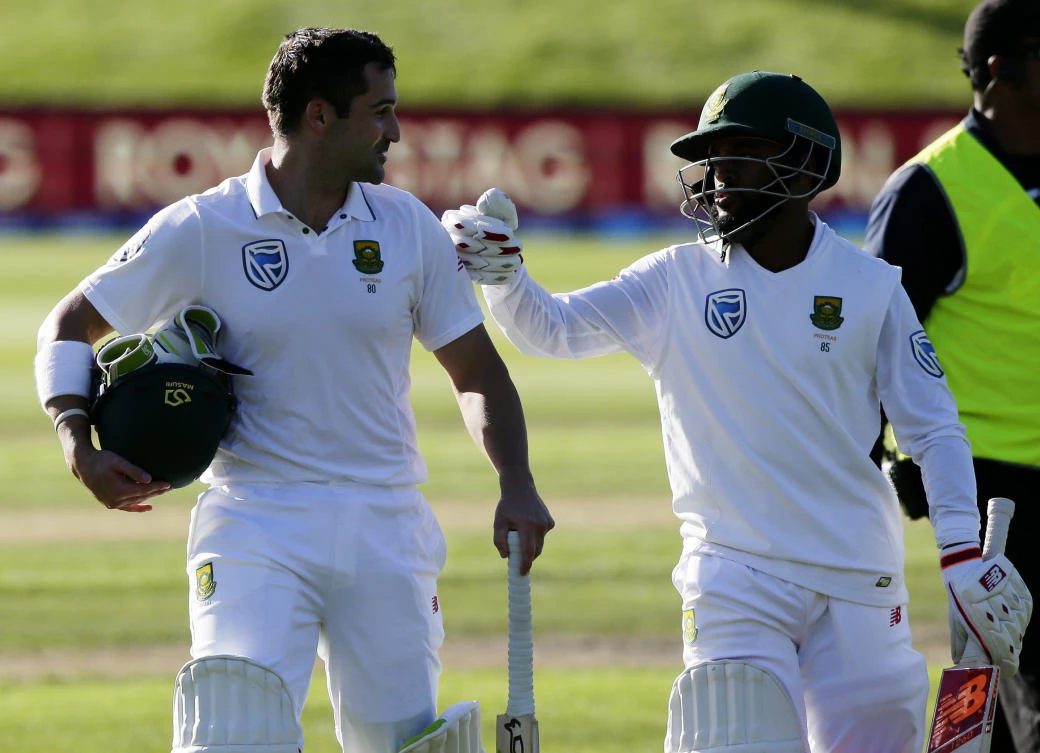 South Africa's Dean Elgar, left, is congratulated by teammate Temba Bavuma after scoring 128 not out as they leave the field following the first day's play of the first cricket Test against New Zealand at University Oval, Dunedin, New Zealand, Wednesday. (AP)