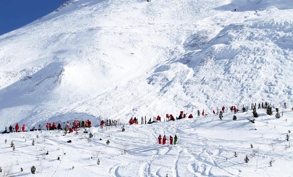 This file handout photo taken and released on February 13, 2017 and made available by Radio Val d'Isere in Tignes, in the French Alps shows an avalanche site in an off-piste area after an avalanche engulfed nine people, killing at least four. (AFP)