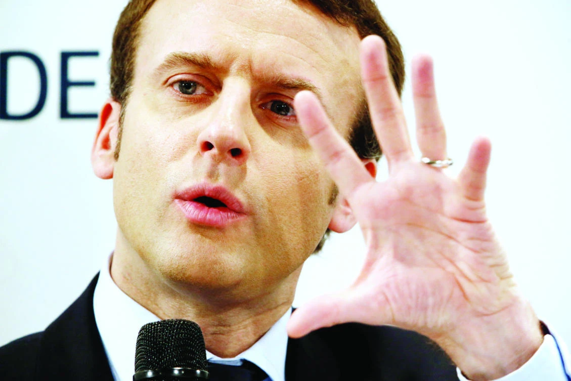 Emmanuel Macron, candidate for the 2017 French presidential election, gestures as he delivers a speech in front of small business leaders in Puteaux, on Monday. (Reuters)