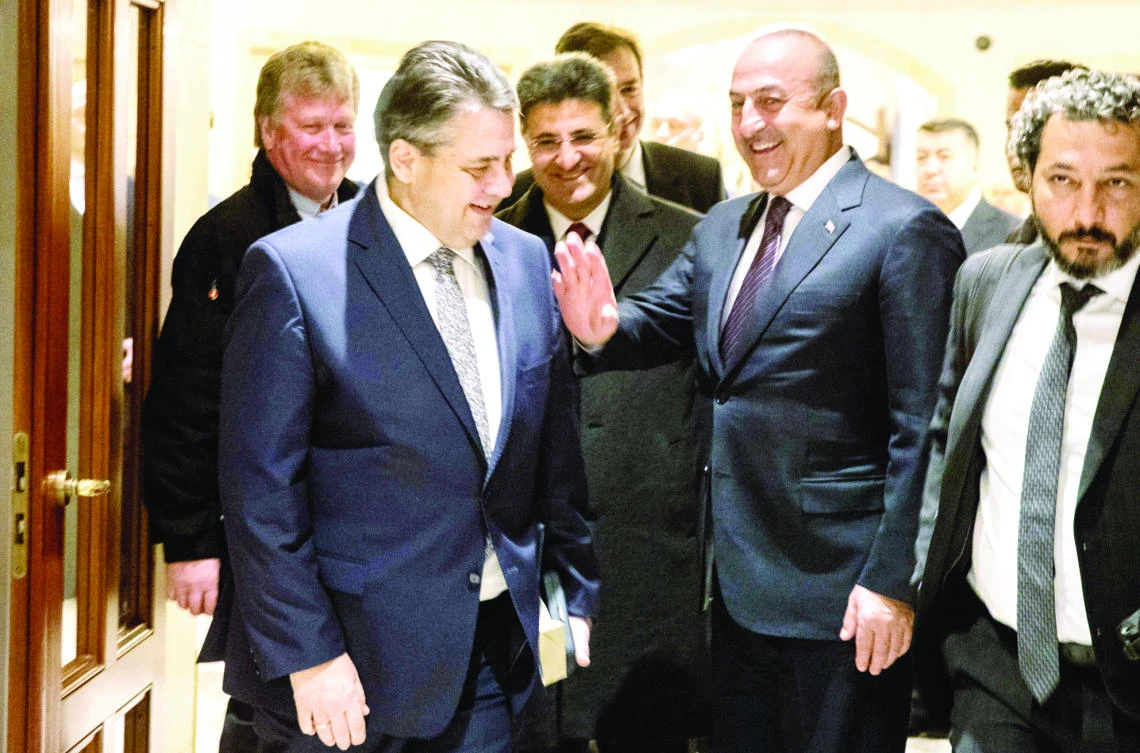 German Foreign Minister Sigmar Gabriel, 2nd left, talks with his Turkish counterpart Mevlut Cavusoglu, 2nd right, on Wednesday at the entrance of the Adlon Hotel in Berlin. (AFP)