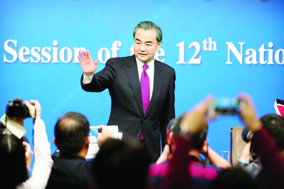 Chinese Foreign Minister Wang Yi waves as he leaves following a press conference held on the sideline of the National People’s Congress at the media center in Beijing on Wednesday. (AP)