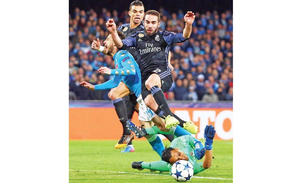 Napoli’s Dries Mertens, left, tries to score against Real Madrid’s defender Dani Carvajal, top right, and Real Madrid’s Costa Rican goalkeeper Keylor Navas during the UEFA Champions League football match SSC Napoli vs. Real Madrid on Tuesday at the San Paolo stadium in Naples. (AFP)