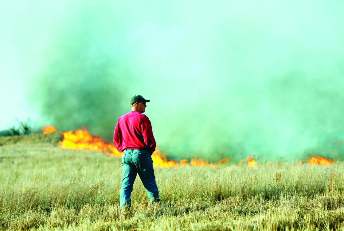 A man watches as a wildfire burns on Sunday, in Hutchinson, Kansas. (AP)