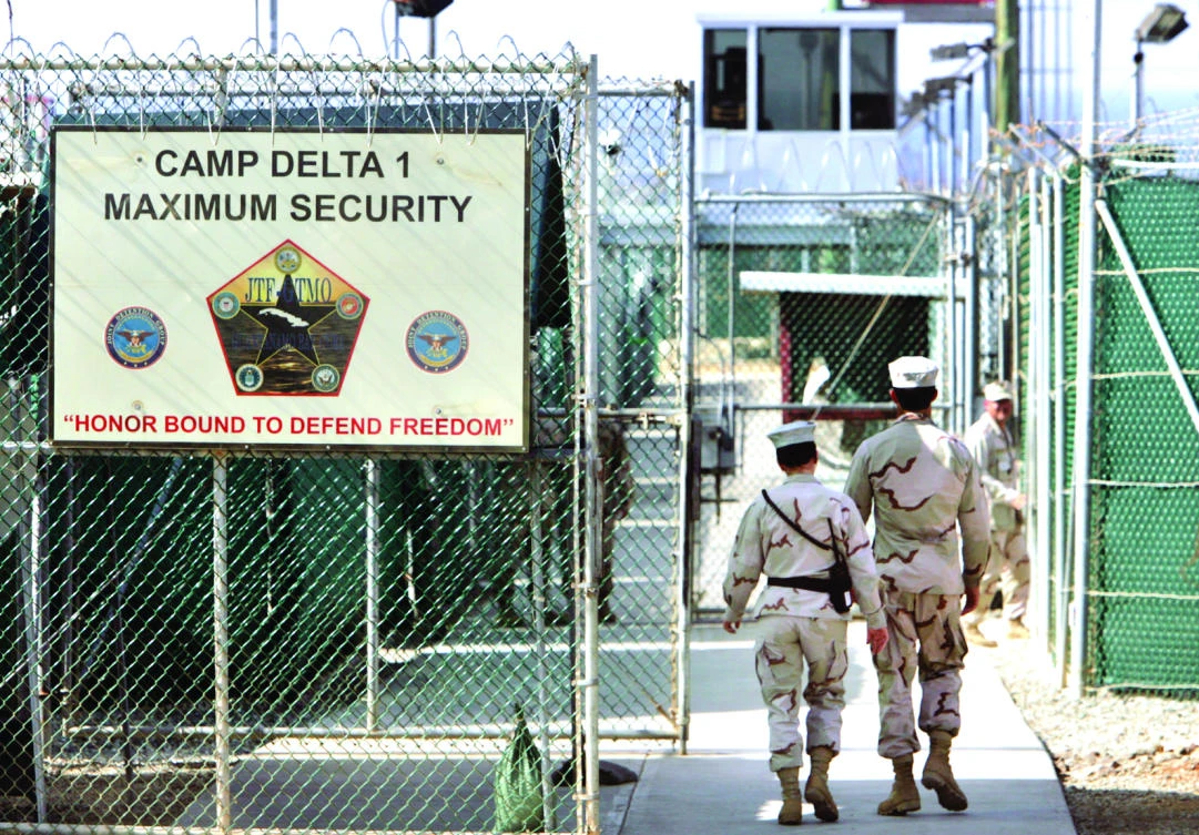 US military guards walk within the Camp Delta military-run prison, at the Guantanamo Bay US Naval Base, Cuba, in this file photo. (AP)