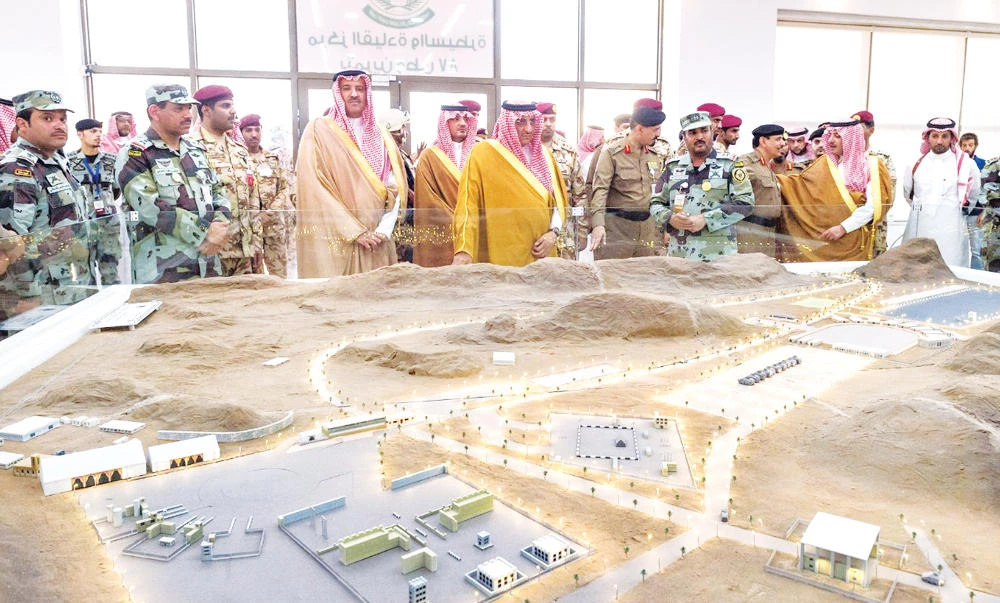 Crown Prince Mohammed bin Naif and Madinah Gov. Prince Faisal bin Salman listen to a briefing at the training area of the Mohammed bin Naif Center for Special Operations and Developed Applications in Madinah on Wednesday. (SPA)