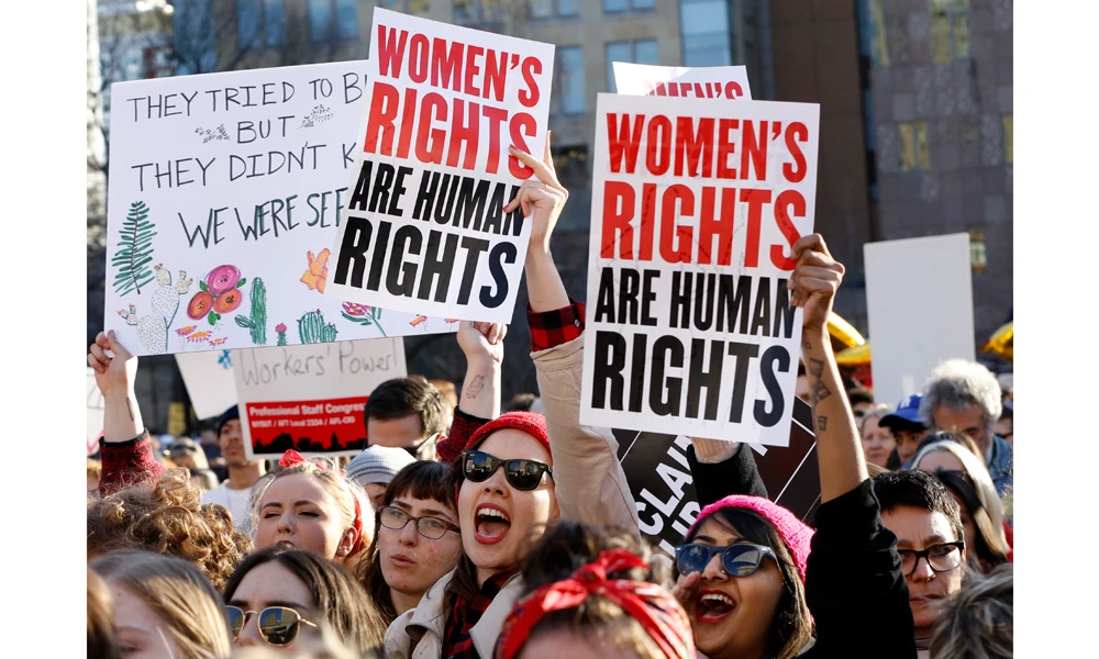 Women chant and raise their signs during a rally, part of International Women's Strike NYC, a coalition of dozens of grassroots groups and labor organizations, Wednesday at Washington Square Park in New York. (AP Photo/Kathy Willens)