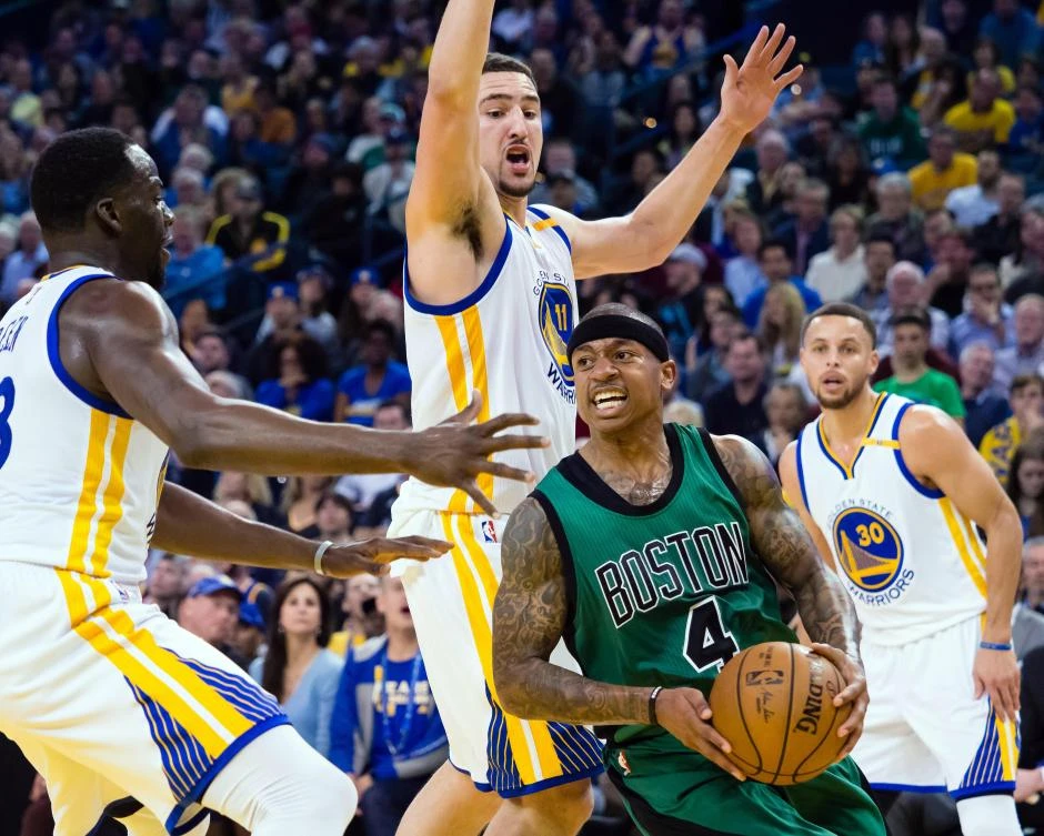 Boston Celtics guard Isaiah Thomas (4) controls the ball between Golden State Warriors forward Draymond Green (23), guard Klay Thompson (11) and guard Stephen Curry (30) during the third quarter at Oracle Arena on Wednesday night. (USA TODAY Sports)