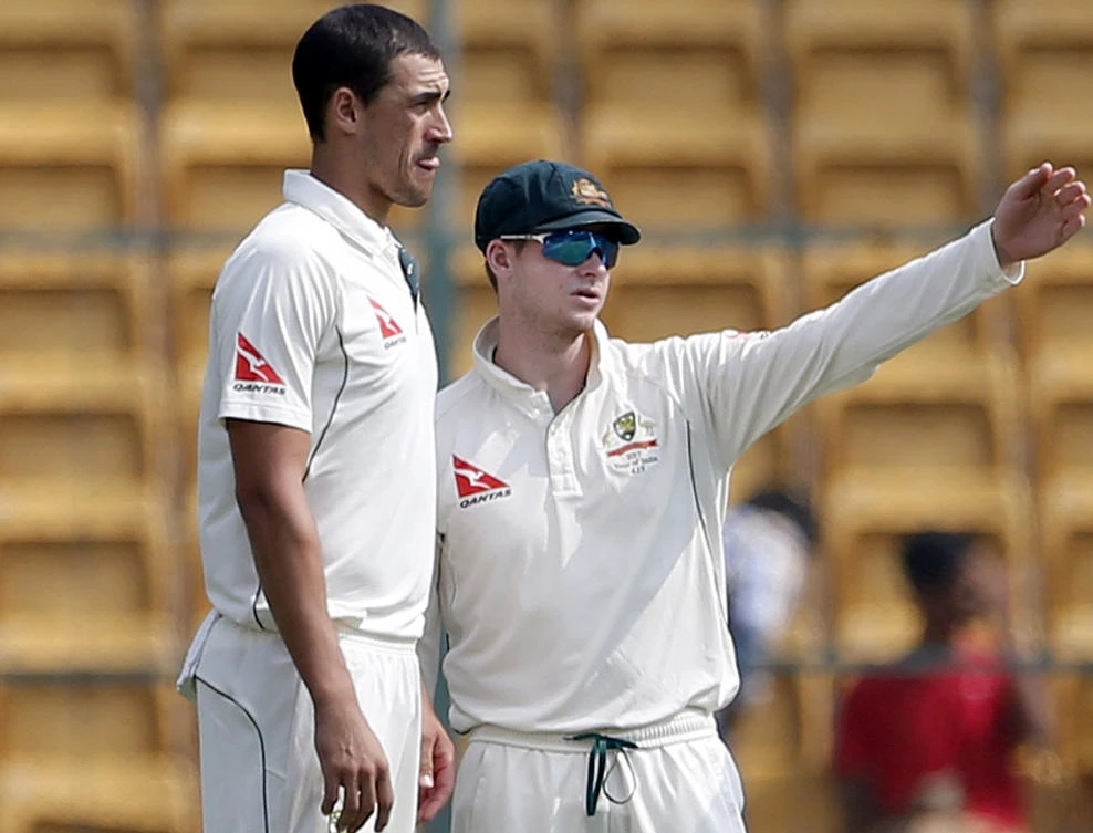 Australia's captain Steve Smith, right, interacts with teammate Mitchell Starc during the fourth day of their second Test match against India in Bangalore on Tuesday. (AP)