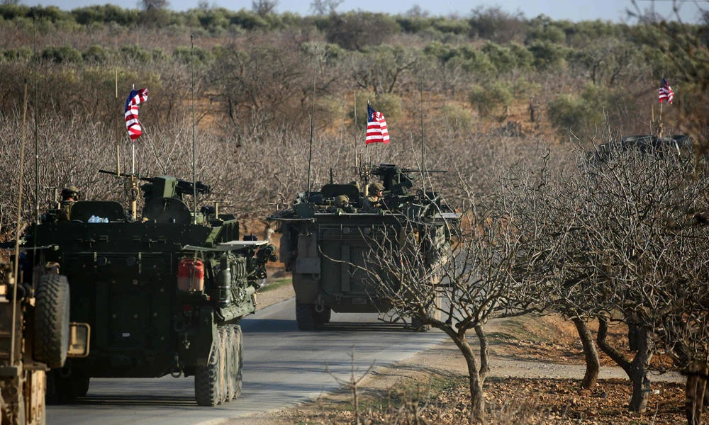 A convoy of US forces armored vehicles drives near the village of Yalanli, on the western outskirts of the northern Syrian city of Manbij, on March 5, 2017. (AFP / DELIL SOULEIMAN)