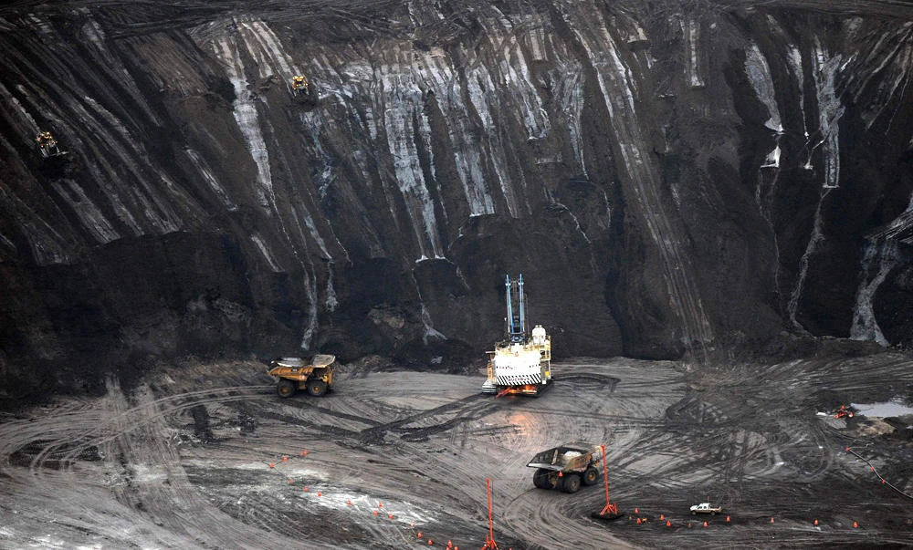 File photo: A large excavator loading a truck with oil sands at the Shell Albian mine near the town of Fort McMurray in Alberta, Canada. (AFP)