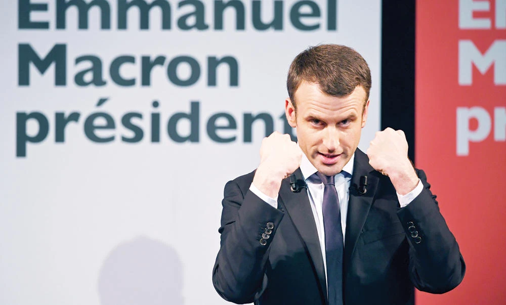 Emmanuel Macron gestures as speaks during an event organized by the collective “Elles Marchent” (They Walk in feminine in French), during International Women’s Day on Wednesday. (AFP)