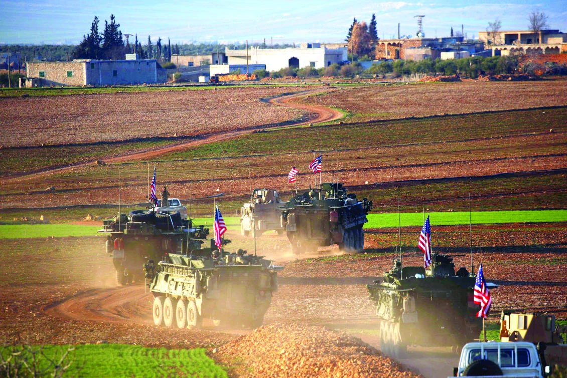 A convoy of US armored vehicles moves near the village of Yalanli, on the western outskirts of the northern Syrian city of Manbij. (AFP)
