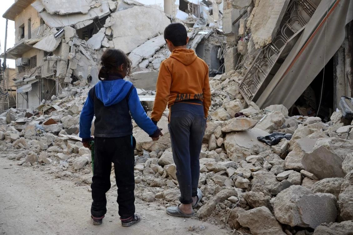 Syrian children stand by in front of the rubble of a destroyed house in the northern Syrian town of Al-Bab. (AFP)