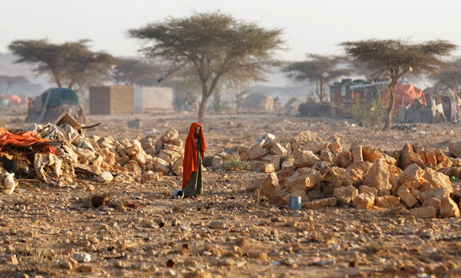 A woman walks through a camp of people displaced from their homes elsewhere in Somalia by the drought. (AP Photo/Ben Curtis)