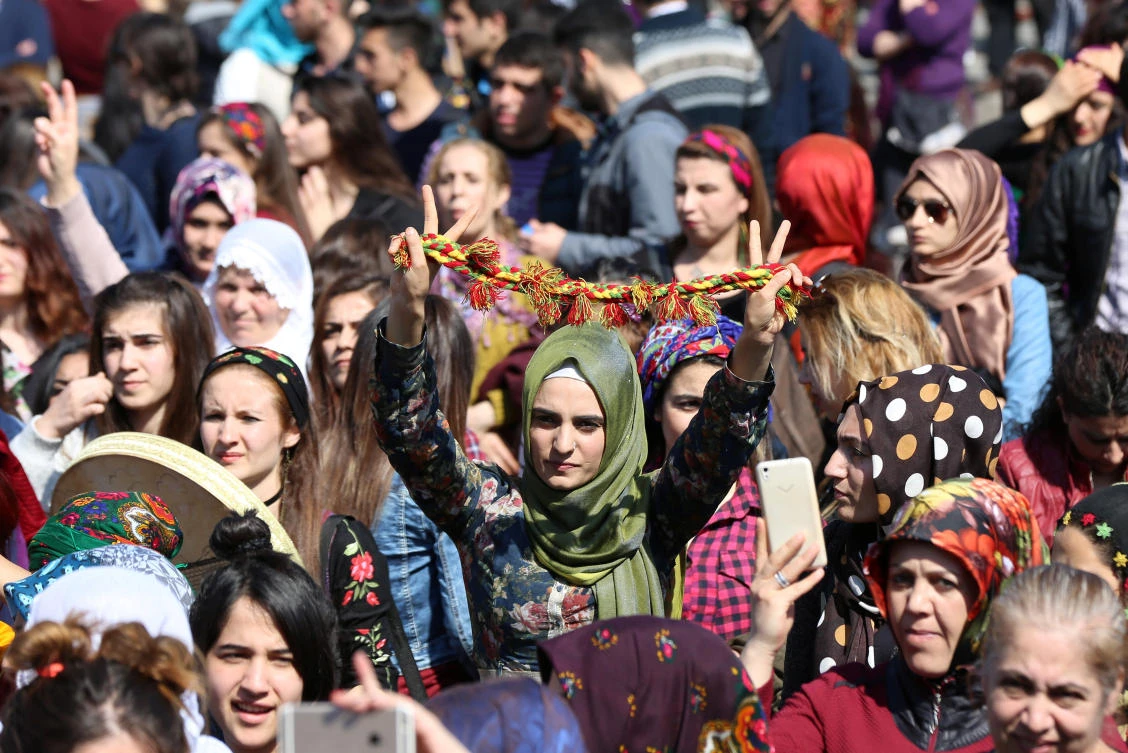 A participant flashes V-signs during an International Women’s Day rally in the Kurdish-dominated southeastern city of Diyarbakir, Turkey. (REUTERS)