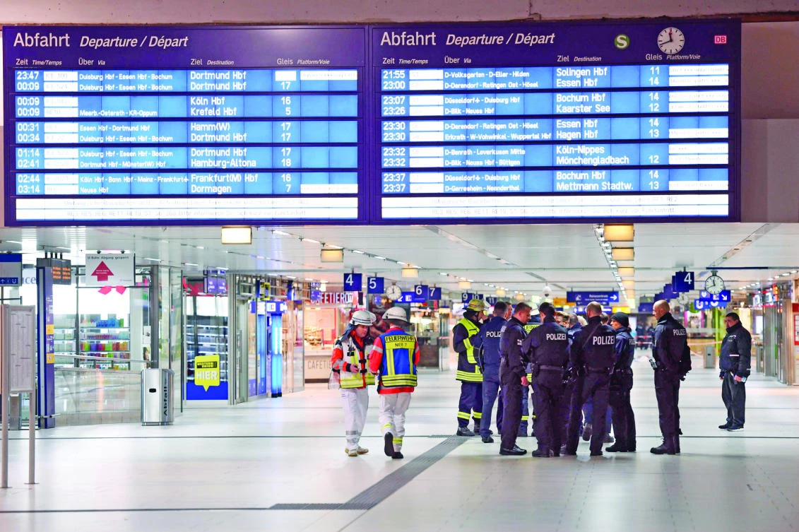 Policemen secure a train station after an axe attack on passengers in Duesseldorf, Germany, on Thursday. (AFP)