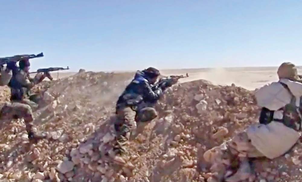 Syria Democratic Forces (SDF) fighters open fire on a Daesh position in Raqqa’s eastern countryside. (AP)
