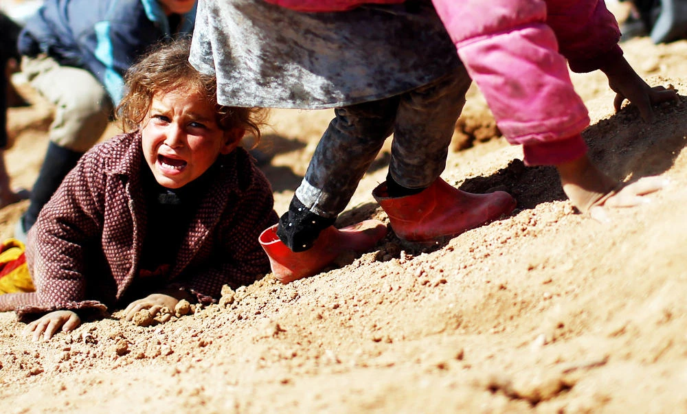 A displaced Iraqi girl cries before entering Hamam al-Alil camp, as Iraqi forces battle with Islamic State militants, south of Mosul, Iraq on Friday. (REUTERS)
