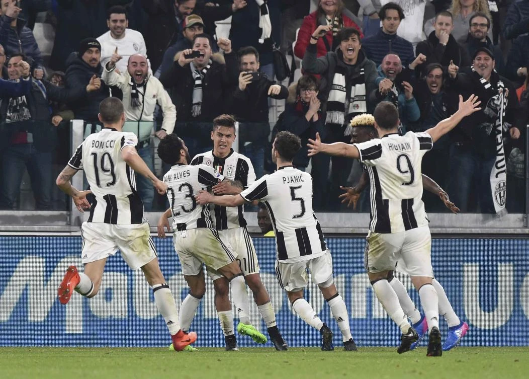 Juventus' Paulo Dybala celebrates with teammates after scoring against AC Milan in the Italian Serie A match at the Juventus Stadium in Turin on Friday night. (Reuters)