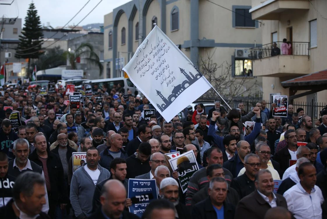 Arab Israelis march in the northern Arab town of Kabul, 14 kilometres southeast of Acre, during a demonstration against a planned Israeli legislation that would quieten mosques, on Saturday. Israel's parliament gave preliminary approval on March 8 to two controversial measures that would limit calls to prayers from mosques, including one prohibiting the use of loudspeakers at all hours, after shouting matches between lawmakers. (AFP/AHMAD GHARABLI)