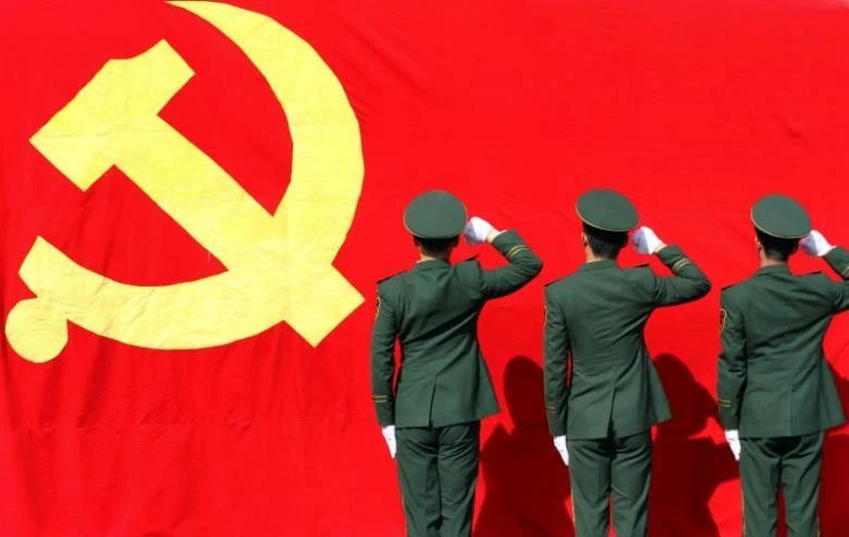 Paramilitary policemen hold their fists in front of a flag of Communist Party of China as they attend an oath-taking rally to ensure the safety of the upcoming 18th National Congress of the Communist Party of China (CPC), at a military base in Hangzhou, Zhejiang province. (REUTERS)
