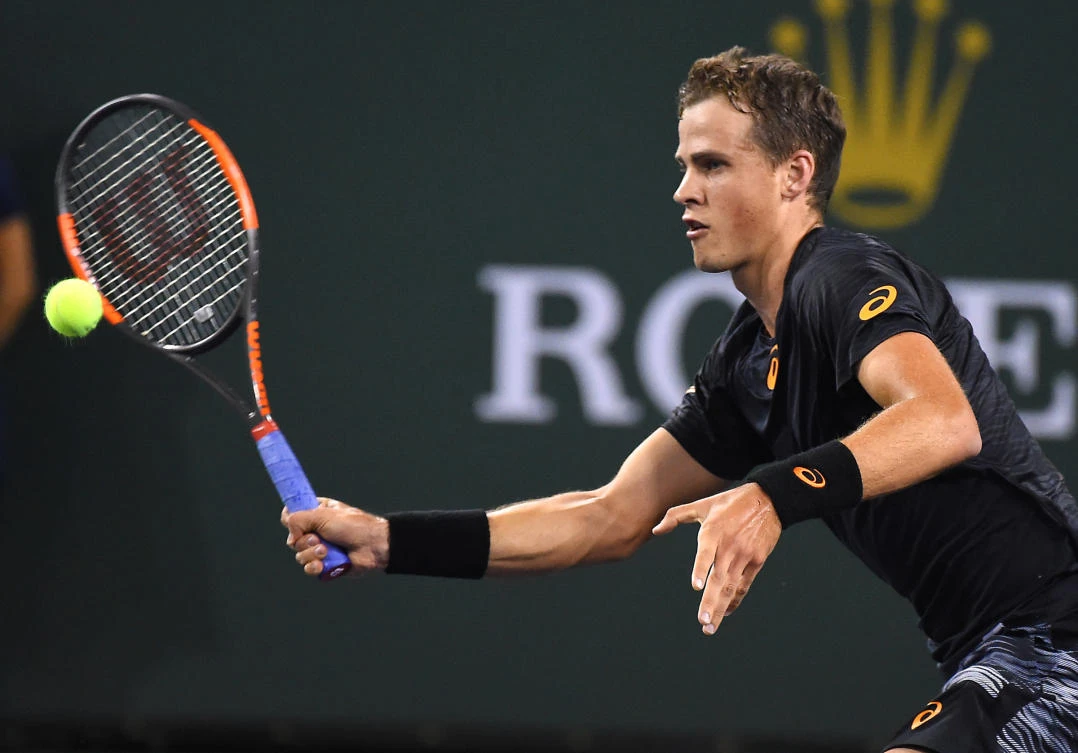 Vasek Pospisil hits a return to Andy Murray during his 2nd round match in BNP Paribas Open at the Indian Wells Tennis Garden on Saturday night. (USA TODAY Sports)