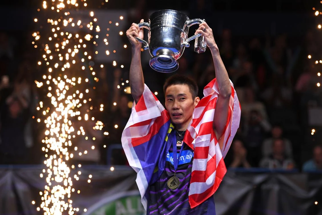 Malaysia's Lee Chong Wei celebrates with the trophy after his victory over China's Lin Dan in the All-England Open Badminton Championships in Birmingham on Sunday. (AFP)
