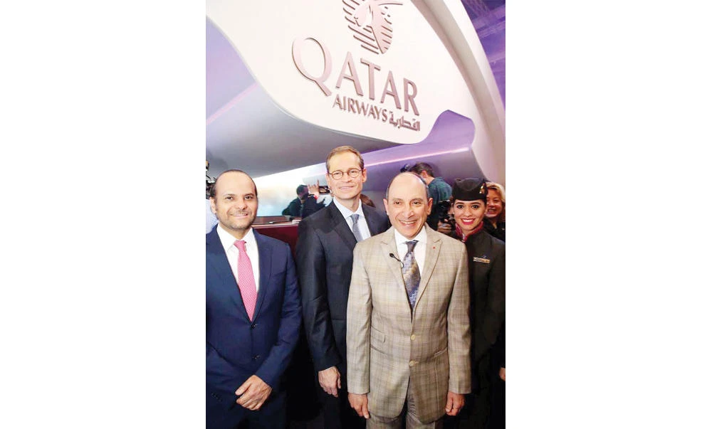 Akbar Al-Baker, chief executive of Qatar Airways Group, right, gestures with Saoud bin Abdulrahman Al-Thani, ambassador of the State of Qatar in Germany, left, and the Mayor of Berlin, Michael Müller, center, at the opening day of ITB exhibition in Berlin.