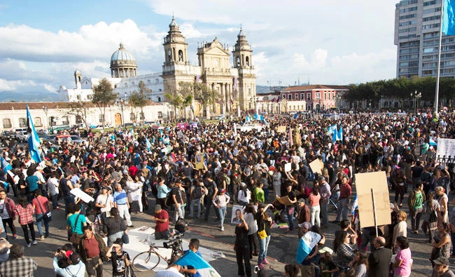 People gather during a protest demanding justice for the girls who perished in the youth shelter fire, in front of the National Palace in Guatemala City, on Saturday. (AP)