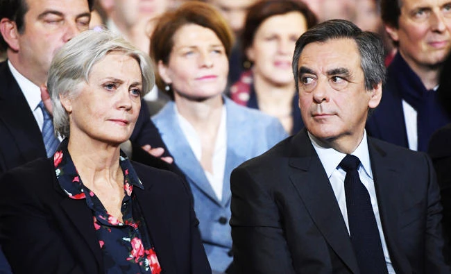 This file photo taken on January 29, 2017 shows French right-wing candidate for the upcoming presidential election Francois Fillon (R) and his wife Penelope (L) during a campaign rally in Paris. (AFP)