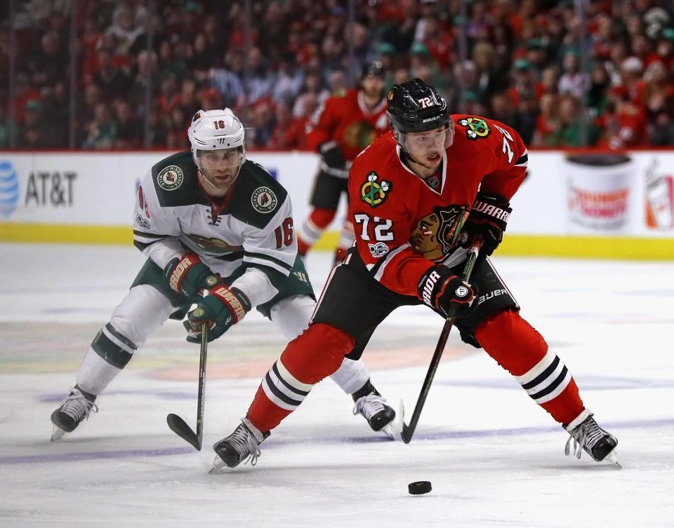 Artemi Panarin (72) of the Chicago Blackhawks advances the puck in front of Jason Zucker (16) of the Minnesota Wild at the United Center in Chicago, Illinois, on Sunday night. (AFP)