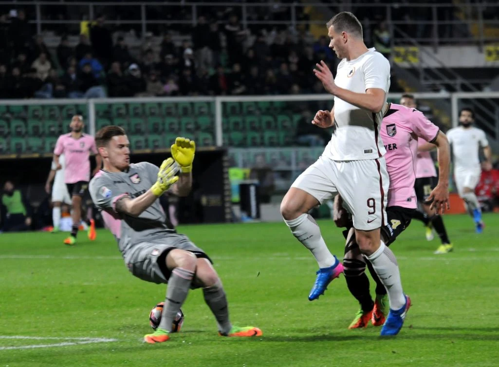 Roma's forward Edin Dzeko, right, scores against Palermo during the Italian Serie A football match on Sunday night. (AFP)