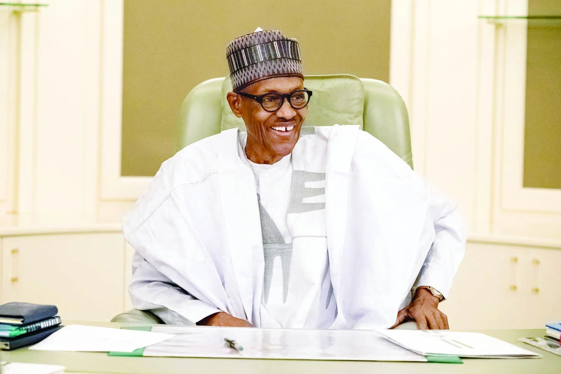 Nigeria’s President Muhammadu Buhari smiles as he resumes work following seven weeks of medical leave, in Abuja on Monday. (Reuters)