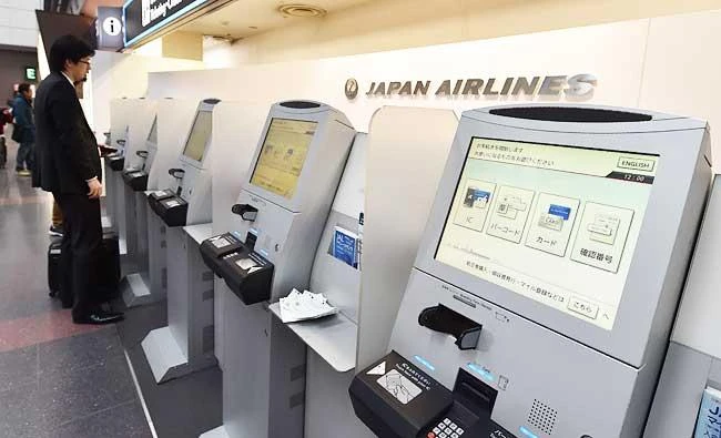 A man stands in front of check-in machines for Japan Airlines on the departures level of Haneda Airport in Tokyo, in this April 1, 2016 file photo. (AFP)