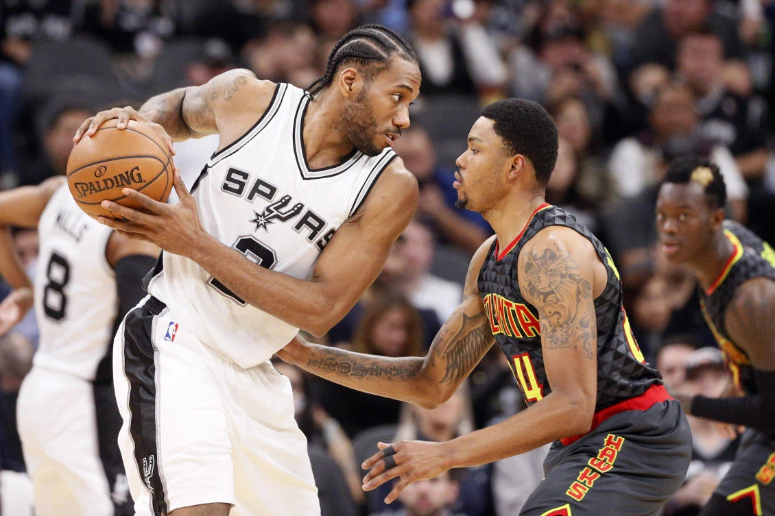 San Antonio Spurs forward Kawhi Leonard (2) holds the ball while defended by Atlanta Hawks small forward Kent Bazemore (24) during the first half at AT&T Center on Monday night. (USA TODAY Sports)