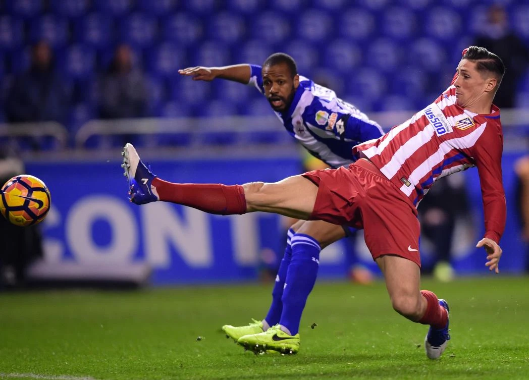 Atletico Madrid's Fernando Torres, right, vies with Deportivo La Coruna's Sidnei during the Spanish league match at the Municipal de Riazor stadium in La Coruna earlier this month. (AFP)