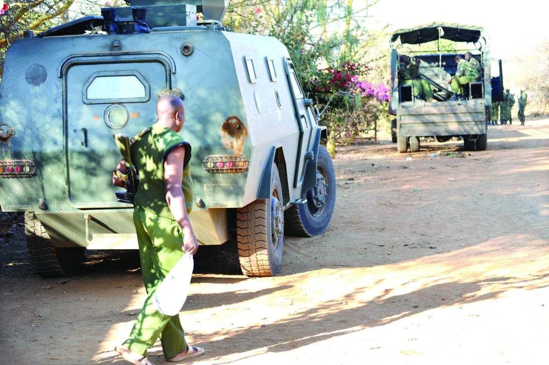 Kenyan police officers arrive after they were deployed to guard Sosian ranch following the killing of Tristan Voorspuy in the drought-stricken Laikipia region. (Reuters)