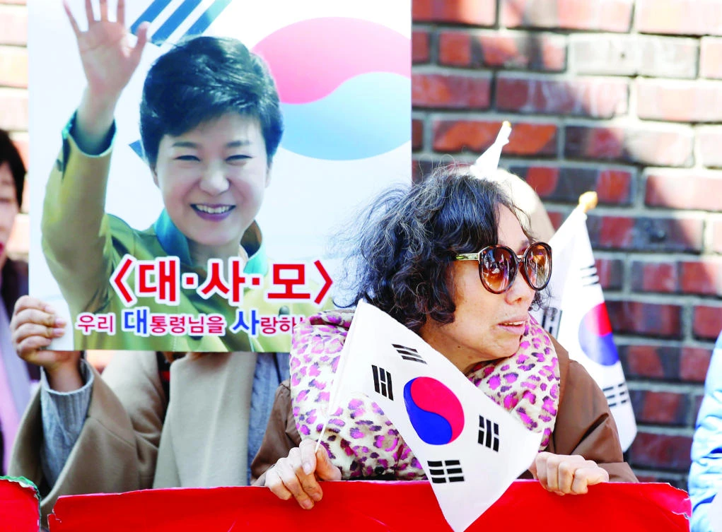 Supporters of South Korea’s ousted leader Park Geun-hye gather outside her private
home in Seoul. (Reuters)