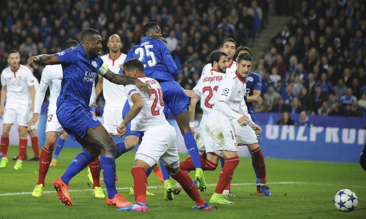 Leicester's Wes Morgan, left, scores a goal against Sevilla during the Champions League round of 16 second-leg match at the King Power Stadium in Leicester on Tuesday night. (AP)