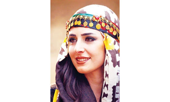 Efin Hissu, a Syrian-Kurdish woman poses on the catwalk during a fashion show displaying a range of traditional Kurdish attire in Qamishli. (AFP)