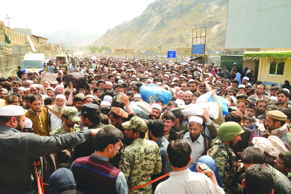 In this March 7, 2017 photo, Afghan nationals prepare to cross the Torkham border post in Pakistan en route to Afghanistan. (AP)