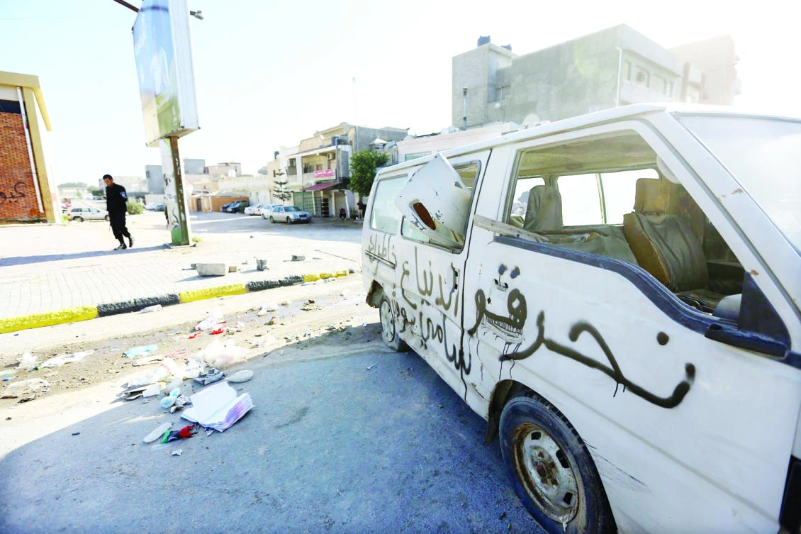 A damaged van lies on a road in the Hay Al-Andalus neighborhood of the Libyan capital Tripoli following clashes between rival armed groups. (AFP)