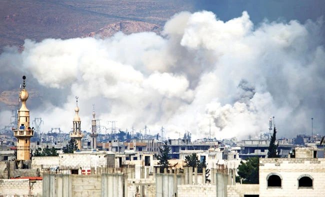 Smoke billows following airstrikes by Syrian regime forces on Damascus’ Al-Qaboun suburb. (AFP)