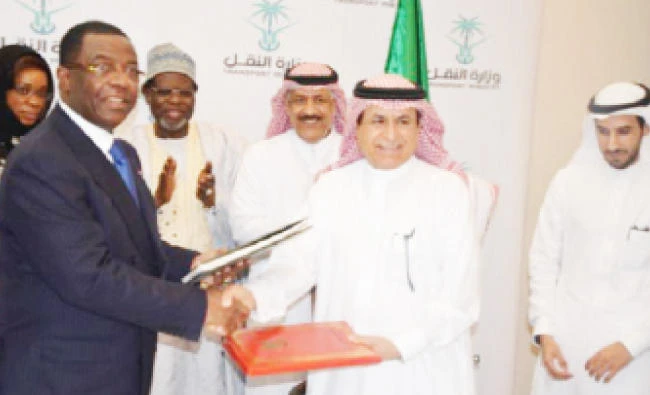 Saudi and Cameroon officials exchange documents at their meeting to discuss the implementation of an air services agreement. (AN photo)