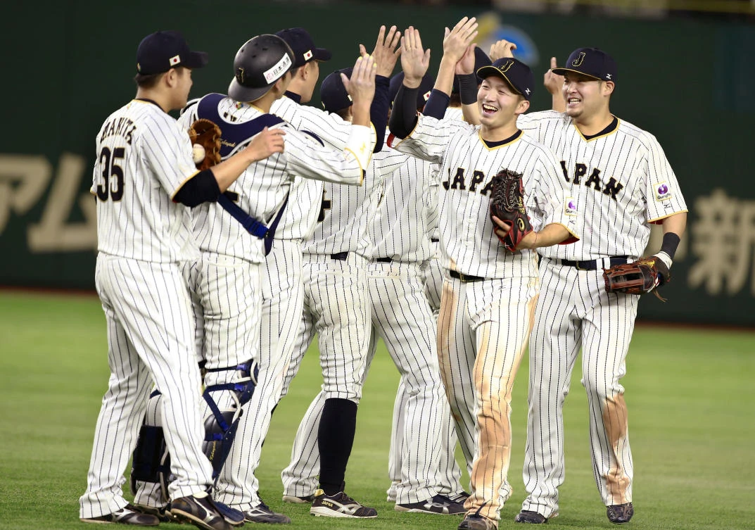 Japan's closer Kazuhisa Makita, left, celebrates with teammates after beating Israel 8-3 in their second round game at the World Baseball Classic at Tokyo Dome late Wednesday. (AP)
