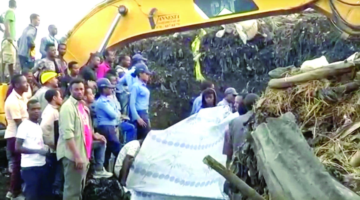 People gather at the site after a landslide at a garbage dump on the outskirts of Addis Ababa, Ethiopia in this still image taken from a video from March 12. (Reuters)