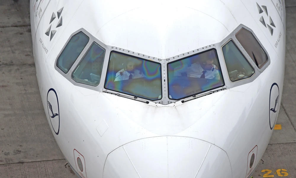 Two pilots sitting in the cockpit of an airplane of German airline Lufthansa at the Franz-Josef-Strauss airport in Munich, in this file photo. (AFP)