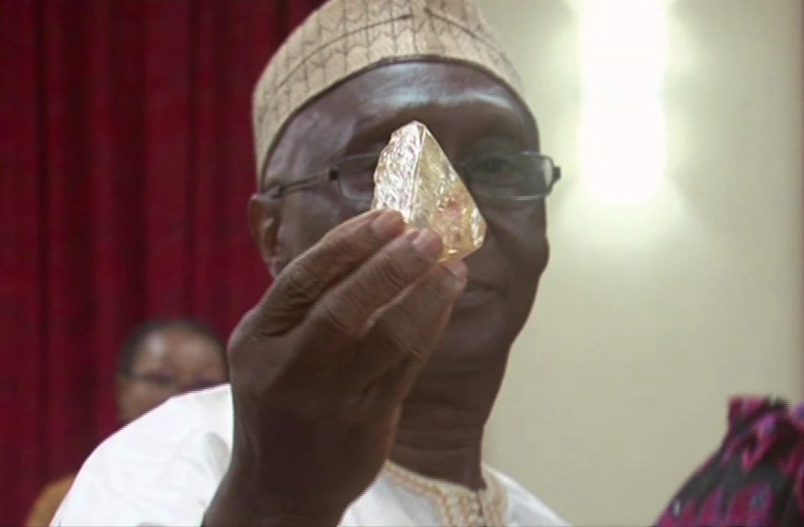 Sierra Leone’s Minister of Mines and Mineral Resources Alhaji Minkailu Mansaray handles a diamond at the presidential office in Freetown, Sierra Leone, Thursday, March 16, 2017. (AP)
