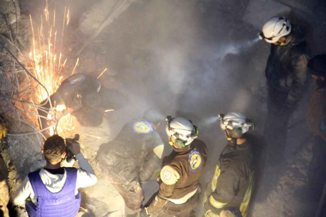 Syrian civil defense volunteers, known as the White Helmets, dig through the rubble of a mosque following a reported airstrike on a mosque in the village of Al-Jineh in Aleppo province. (AFP)