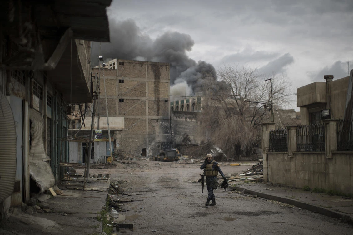 A Federal Police talks on the radio during fighting against Daesh militants in western Mosul, Iraq. (AP)